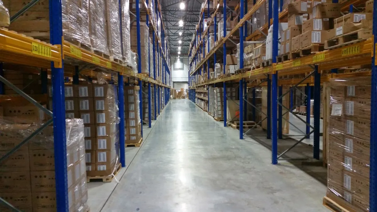 Rows of boxed inventory on shelving in a warehouse.