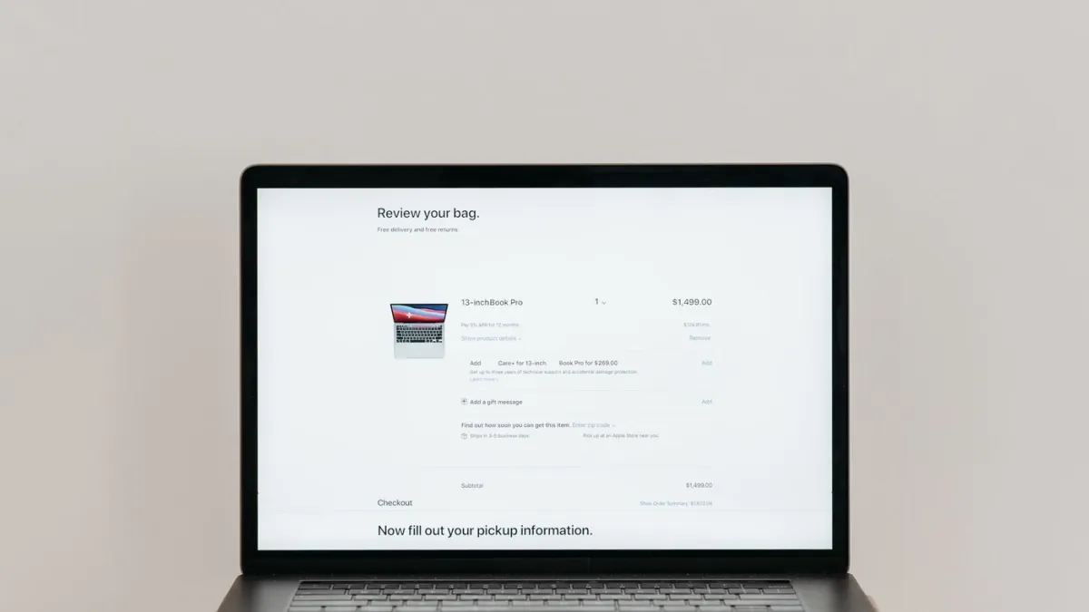 Laptop displaying an online checkout and customer order summary.