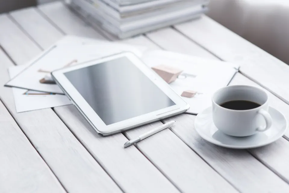 Tablet displaying mobile wireframes beside a stylus